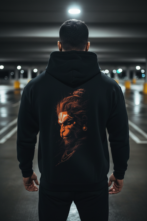 Man wearing Hanuman Hoodie showcasing the artistic design of Hanuman's face in a modern urban setting.